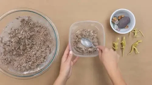 three bowls of mixture and dinosaur figurines