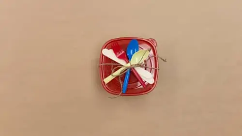 plastic silverware tied to Tupperware with twine